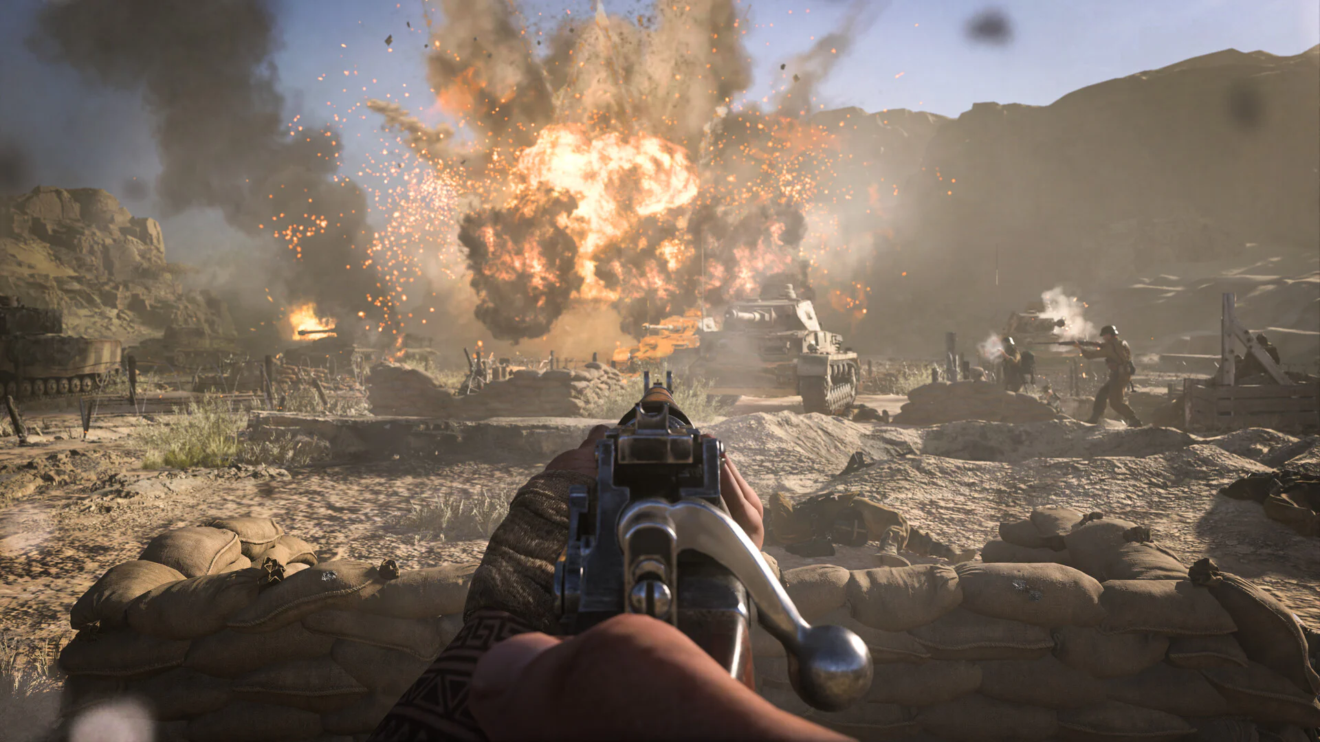 Сцена боя в игре Call of Duty Vanguard, вид от первого лица, солдат стреляет по врагам, на заднем плане взрывы и танки.