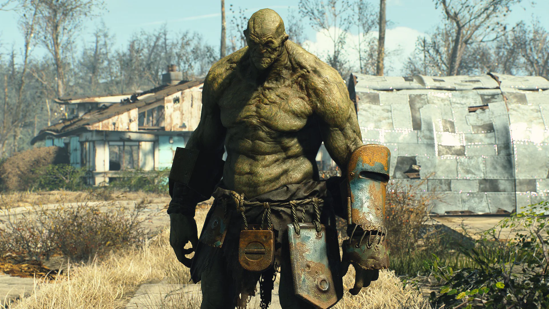 Супермутант на фоне разрушенного дома в игре Fallout 4.