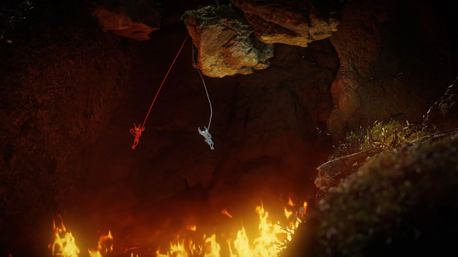 Ярни и его напарник висят на нитях над огненной пропастью в Unravel Two